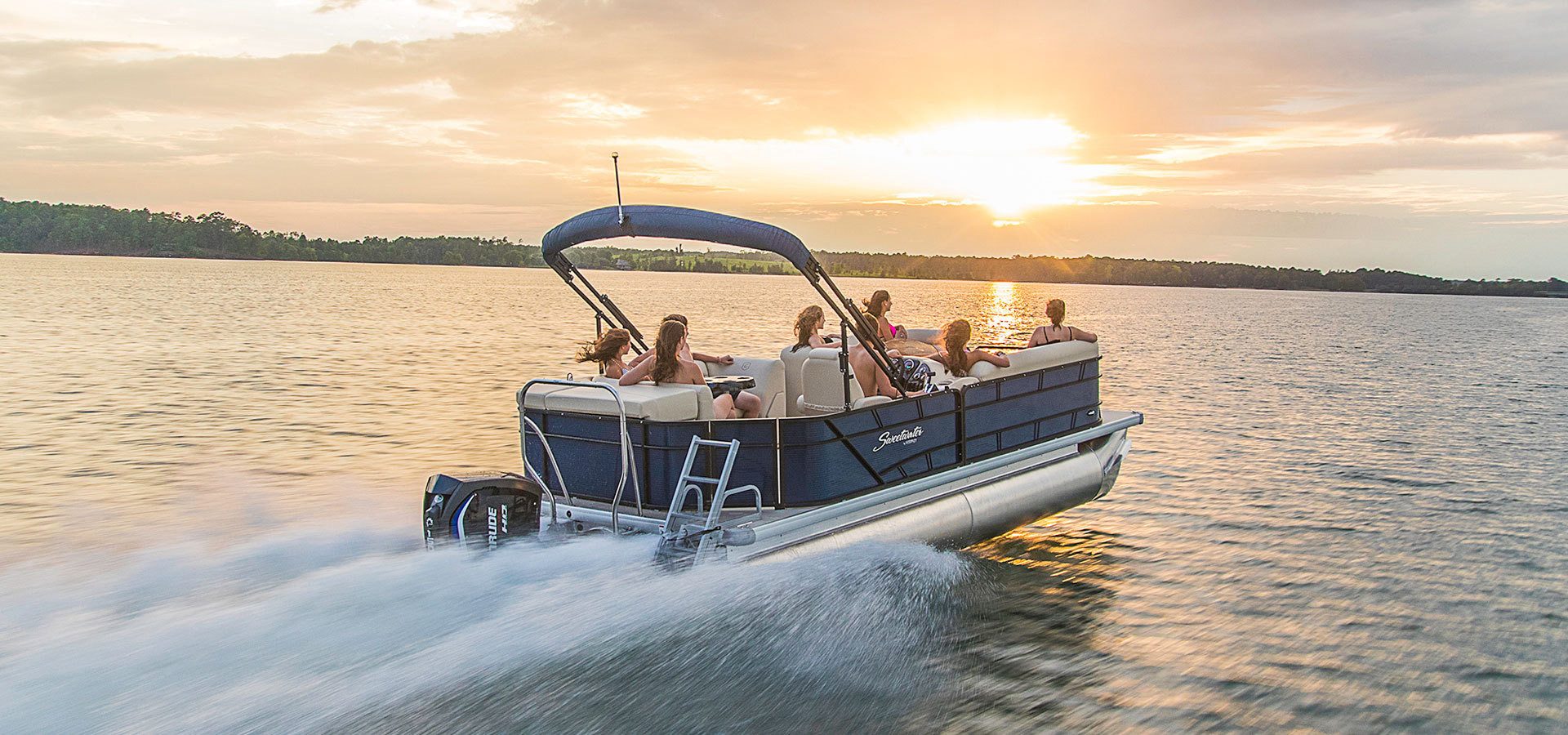 Boat cruising past the Outer Banks coastline at golden hour